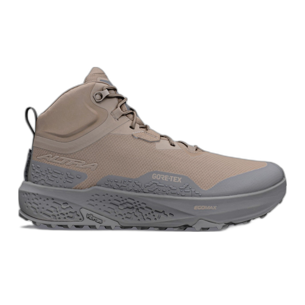 נעל ריצת שטח אטומה למים מדגם Altra TIMP 6 MID GTX בצבע בז', עם סוליה אפורת עבה ומרקמת ולשונית משיכה בעקב.