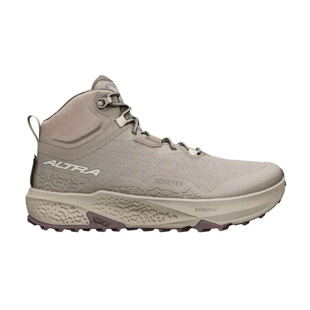 דגם Altra TIMP 6 MID GTX TAN A0A85UR922 הוא נעל טיולים גבוהה בצבעי בז' וטאופ, הכוללת סוליה מחוספסת, עיצוב עם שרוכים ולוגו המותג Altra.