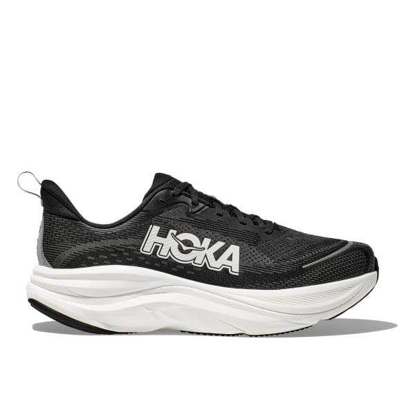 Hoka SKYFLOW WIDE (2E) 1155117/BWHT היא נעל אתלטית בשחור-לבן המציגה סוליה לבנה עבה, שרוכים שחורים, ואת הלוגו החתימה של Hoka בצד.