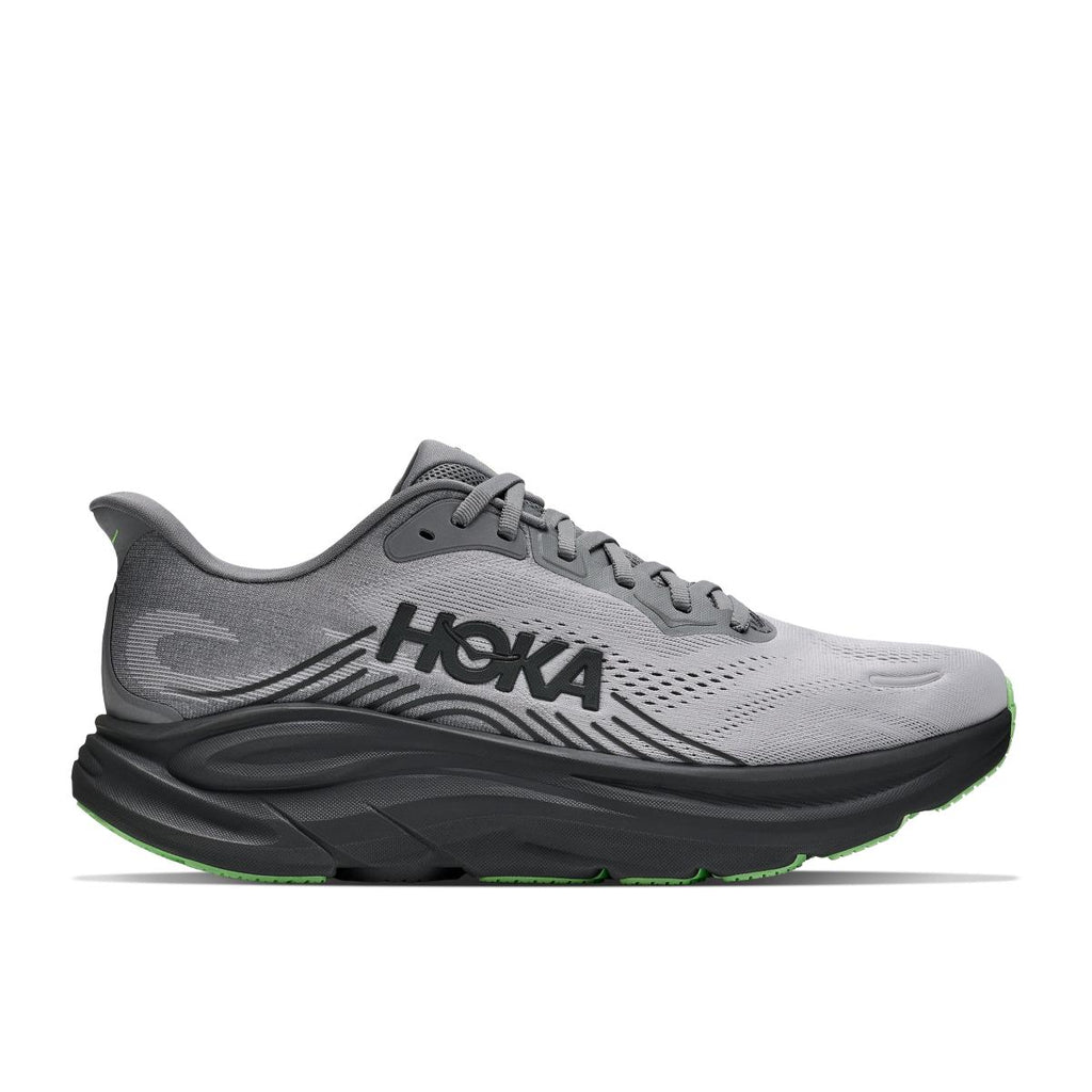 נעל ריצה Hoka Clifton 11 Wide (2E) לגברים בצבע Galactic Grey/Star במבט צדדי, עם גפת רשת אפורה, סוליה אמצעית שחורה עבה ונגיעות ירוק ליים בסוליה החיצונית