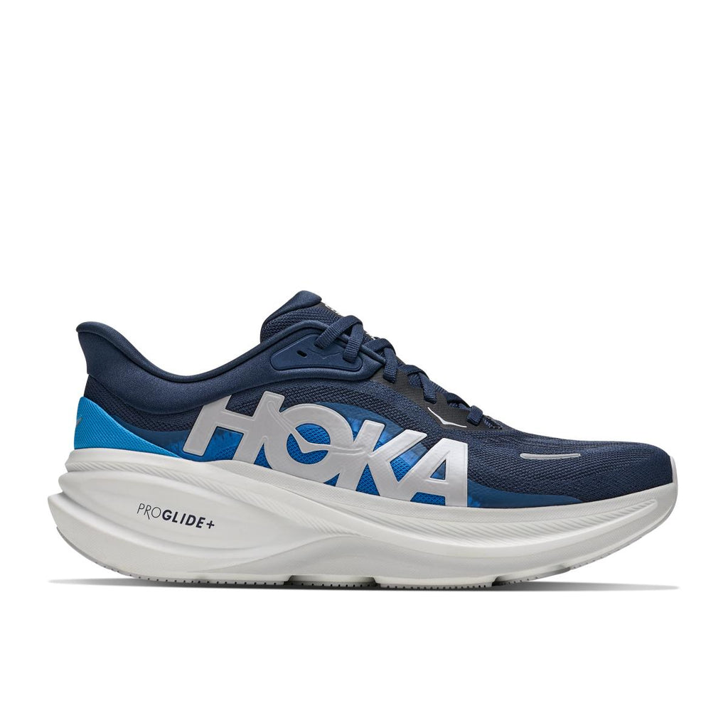 נעלי ריצה Hoka Clifton Pro Wide 2E לגברים בצבע Varsity Navy – מבט צד עם סוליה לבנה עבה ולוגו Hoka.